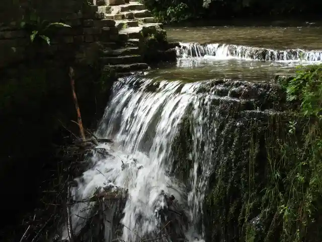 A photo of Tranquil Waterfall and Stone Steps at Kearsney Abbey Gardens